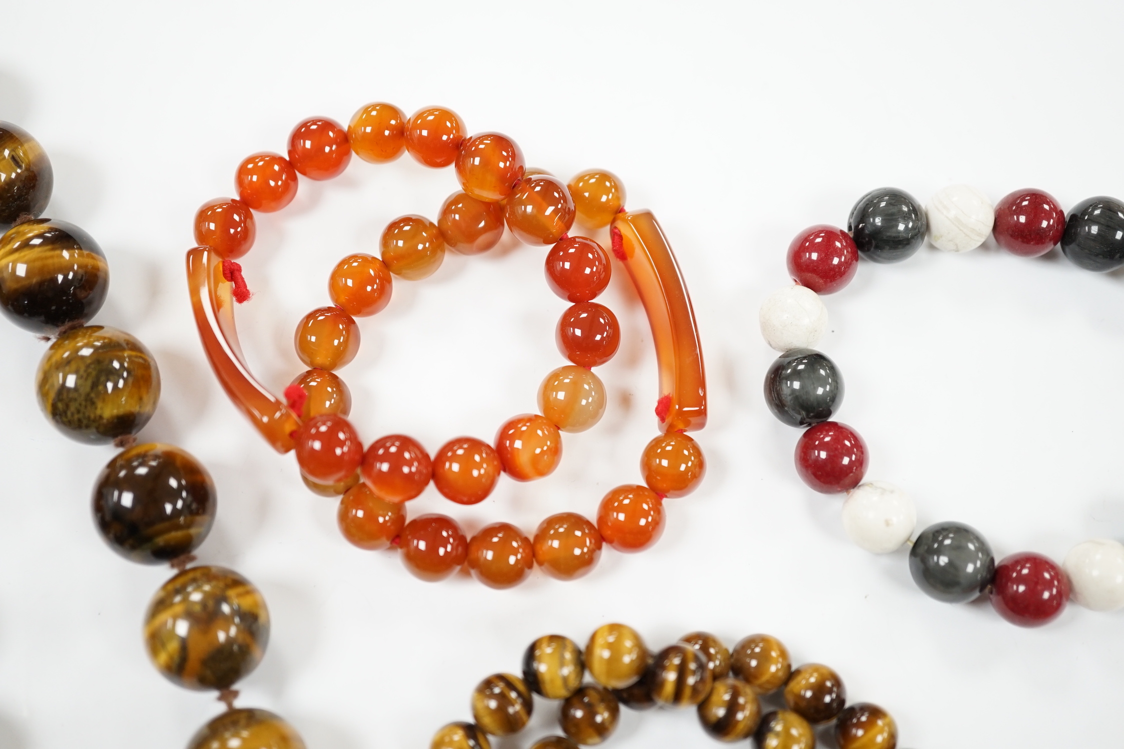 A tiger's eye quartz bead necklace, 44cm and two tiger's eye quartz bracelets, together with other bracelets including agate and loose beads.